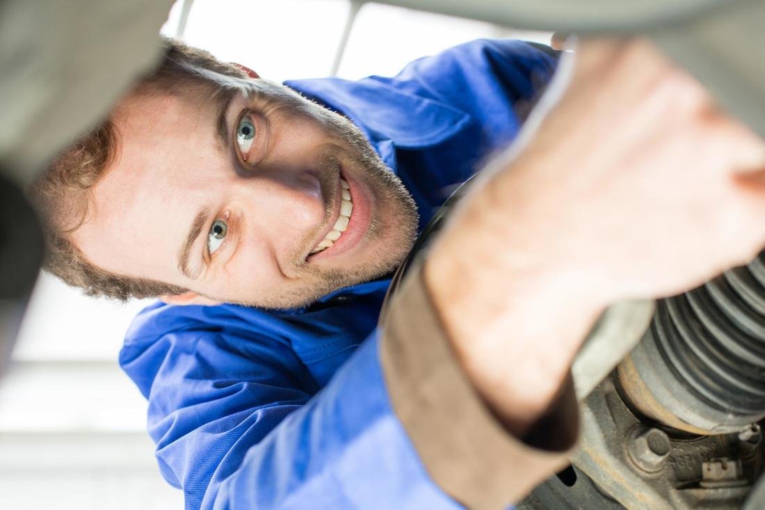NO CODE EXECUTION ALLOWED HERE mechanic inspecting brakes